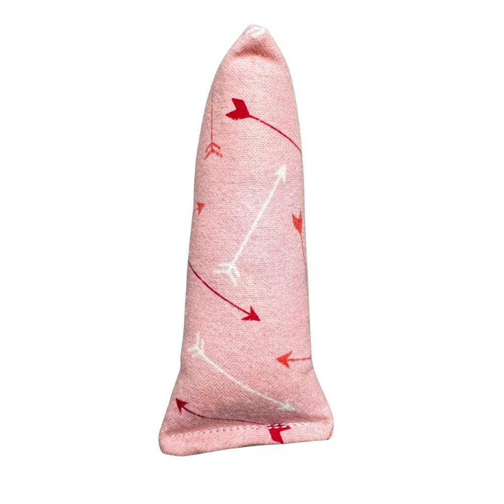 Close-up photo of one handmade Valentine arrows Mini Kicker cat toy in a soft pink arrows pattern, compact shape, filled with signature premium catnip. Made by CatnipTakeout.