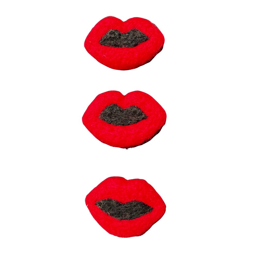 Three handmade red wool lips cat toys with black felt detail on a white background, from CatnipTakeout’s wool collection, sprayed with signature catnip spray.